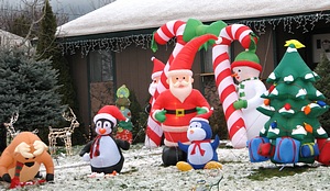 Christmas inflatables decorating house lawn covered with snow